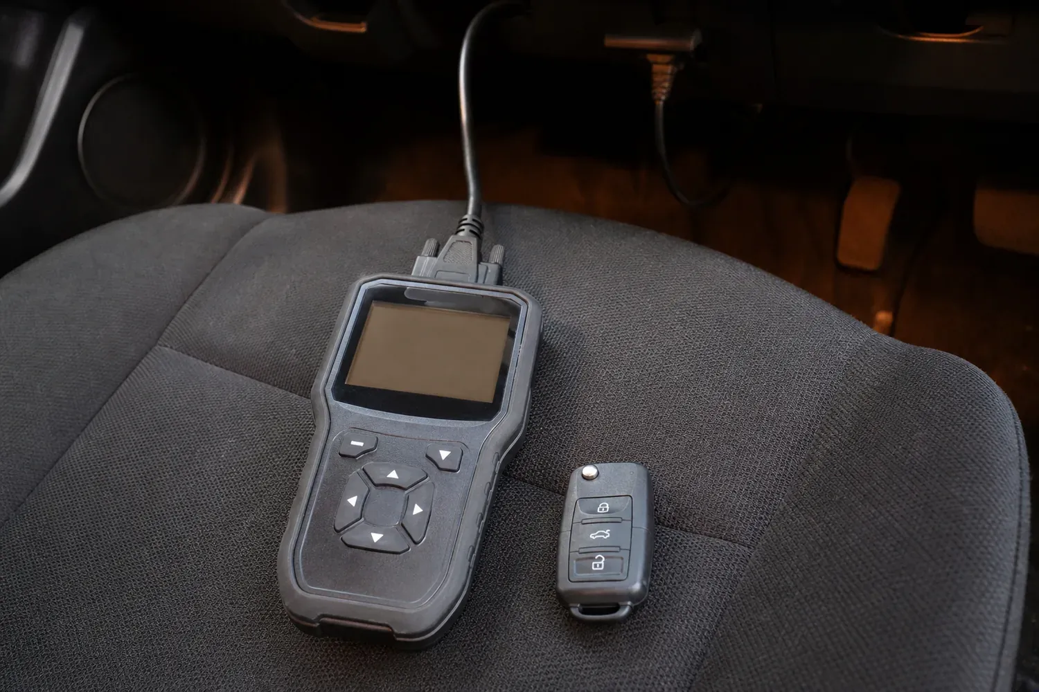 Car key programmer plugged into the OBD port